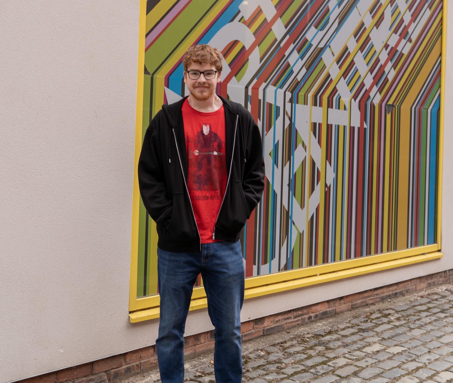 Student standing in front of art centre